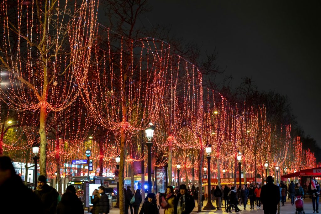 Gente paseando por los Campos Elíseos de París iluminados por Navidad